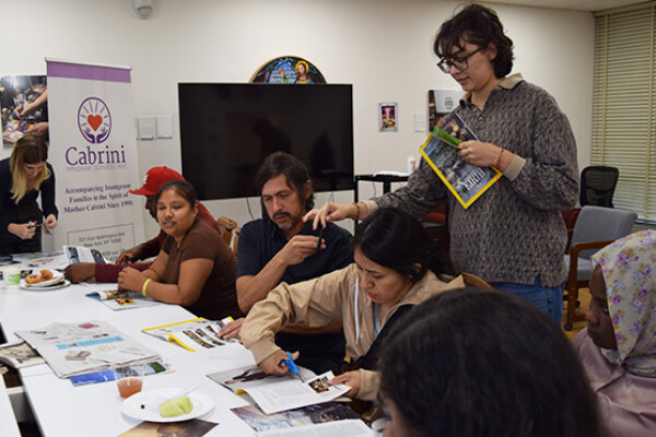 CIS-NYC staff and clients create a collage for the World Day of Migrants and Refugees